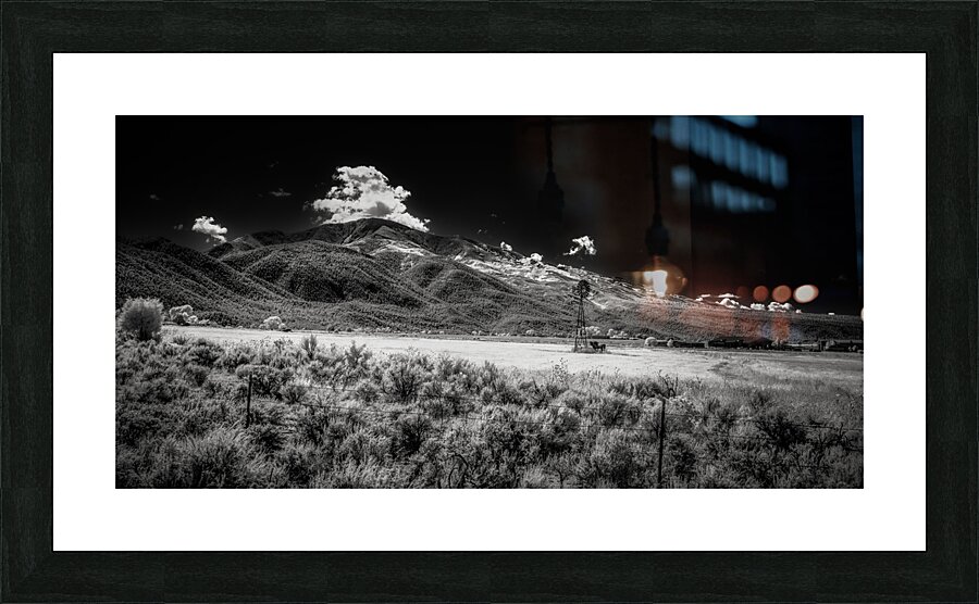Isolated Windmill Beneath Rugged Peaks Picture Frame print